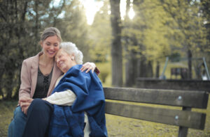 Woman with elderly woman outside